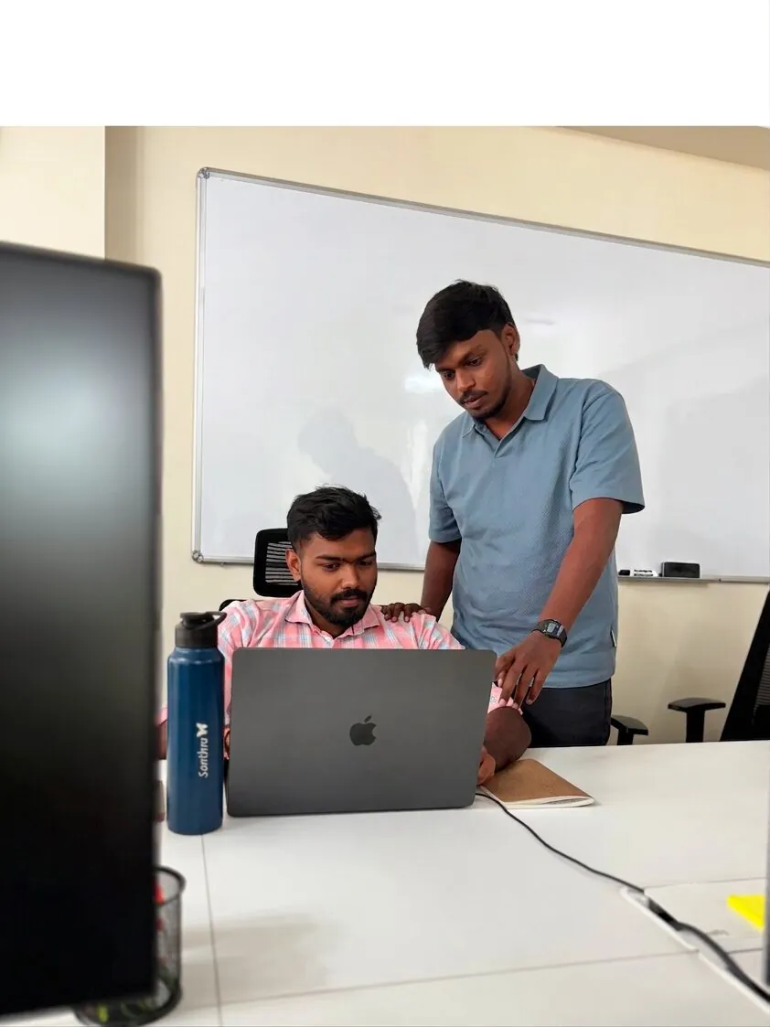 Two India Satcom engineers reviewing work together at a workstation